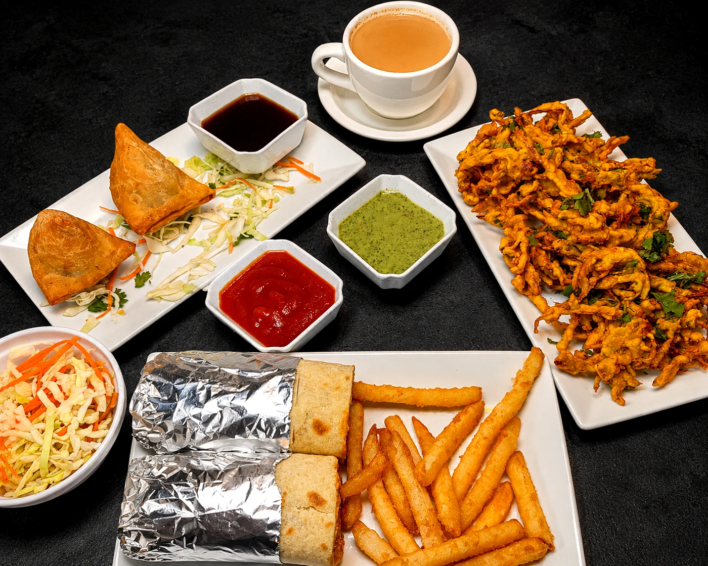 Samosa, pakora and a kathi roll with chai