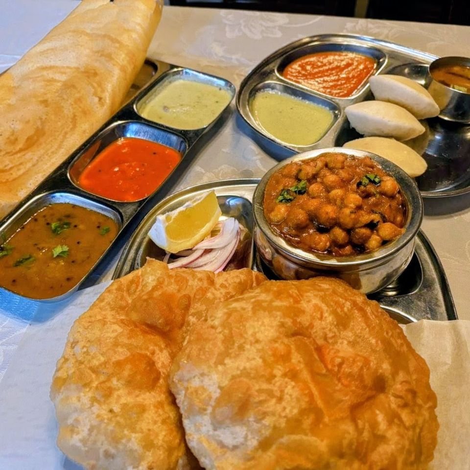 Masala dosa with chutneys and sambar, idli, and chole bhature