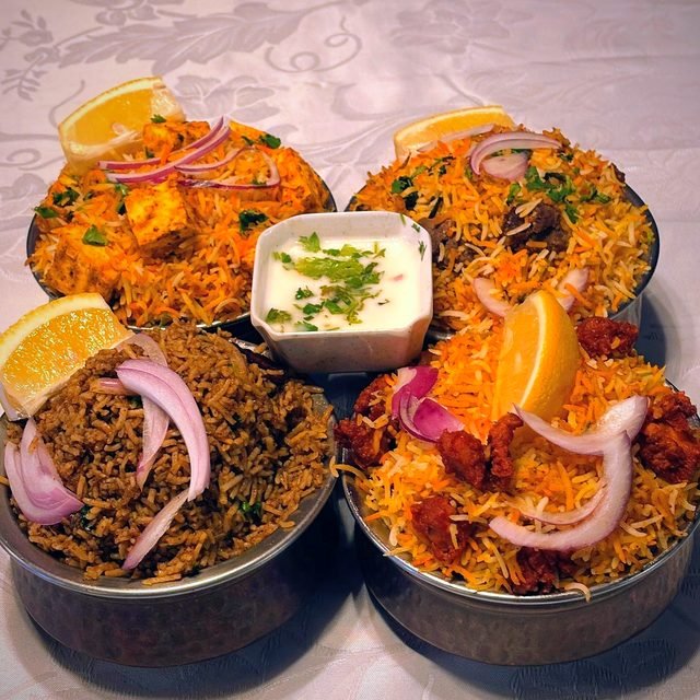 Dum biryani in steel handis with raita